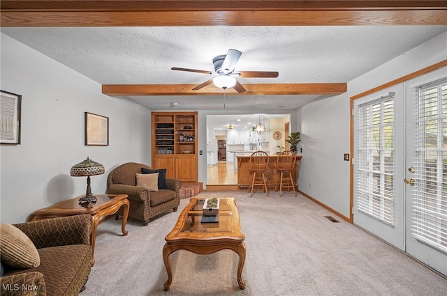 16538 S White Oaks Dr, Strongsville, OH 44136 - carpeted living room with ceiling fan, french doors, a textured ceiling, baseboards, and beamed ceiling