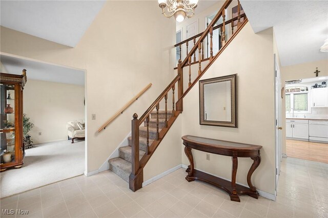 16538 S White Oaks Dr, Strongsville, OH 44136 - stairway with a chandelier, baseboards, and a towering ceiling