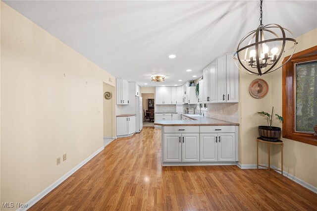 16538 S White Oaks Dr, Strongsville, OH 44136 - kitchen with white appliances, a chandelier, light wood finished floors, and recessed lighting
