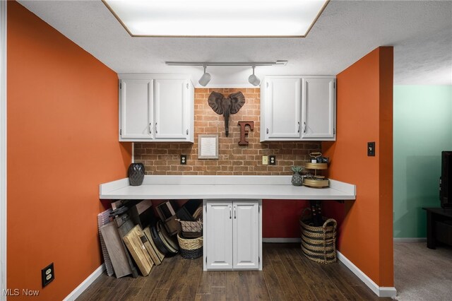 16538 S White Oaks Dr, Strongsville, OH 44136 - bar featuring dark wood finished floors, baseboards, track lighting, and decorative backsplash