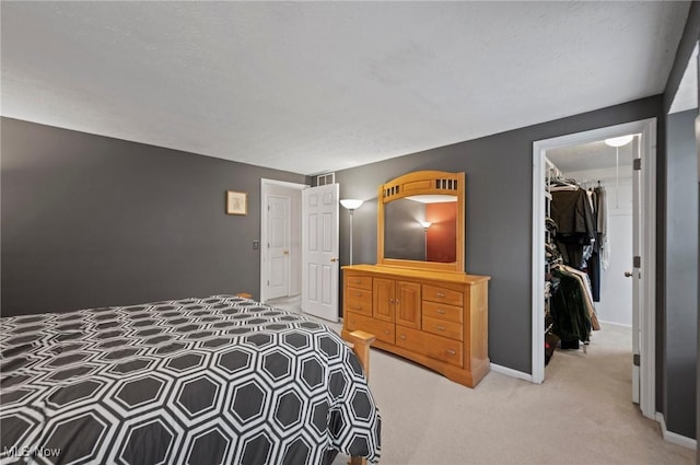 16538 S White Oaks Dr, Strongsville, OH 44136 - bedroom with a walk in closet, a closet, light colored carpet, and baseboards