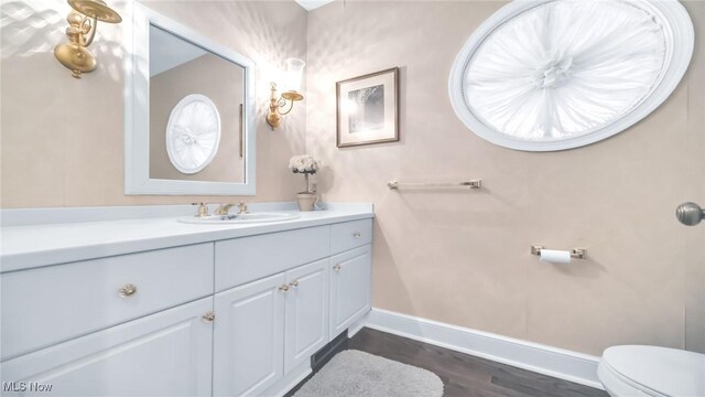 5 W Mather Ln Unit 5, Bratenahl, OH 44108 - bathroom with baseboards, vanity, toilet, and wood finished floors