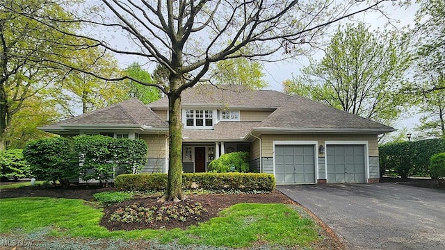 5 W Mather Ln Unit 5, Bratenahl, OH 44108 - view of front of home featuring an attached garage, driveway, and a shingled roof