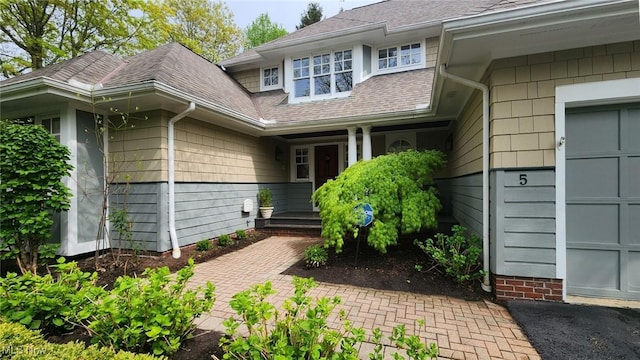 5 W Mather Ln Unit 5, Bratenahl, OH 44108 - entrance to property featuring a garage and a shingled roof