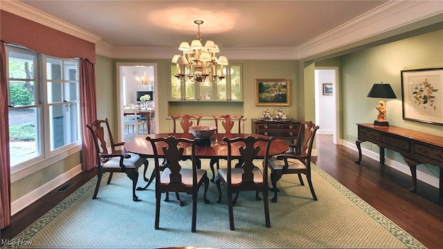 5 W Mather Ln Unit 5, Bratenahl, OH 44108 - dining area with a chandelier, dark wood-style floors, healthy amount of natural light, ornamental molding, and baseboards