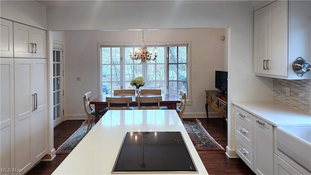 5 W Mather Ln Unit 5, Bratenahl, OH 44108 - dining area featuring a chandelier, dark wood finished floors, and baseboards