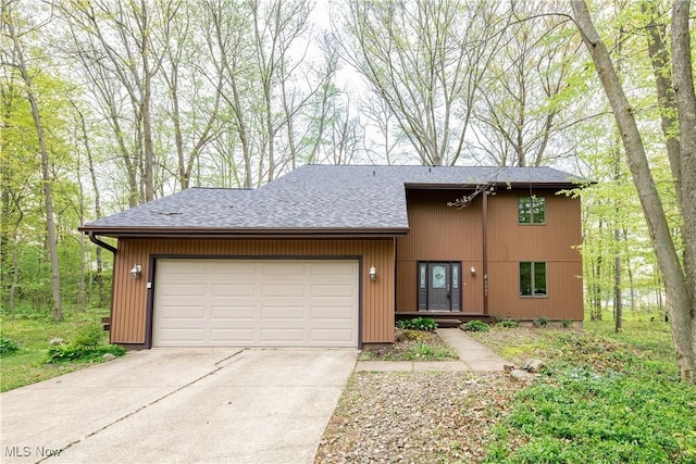 1537 Plantation Dr, Hudson, OH 44236 - view of front of home with a garage, concrete driveway, and roof with shingles
