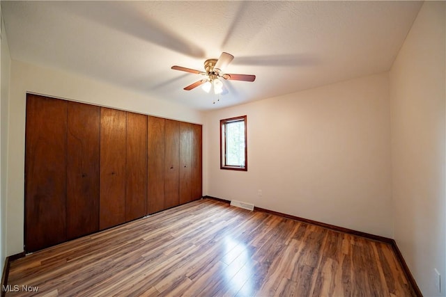 1537 Plantation Dr, Hudson, OH 44236 - unfurnished bedroom with baseboards, wood finished floors, a closet, and ceiling fan