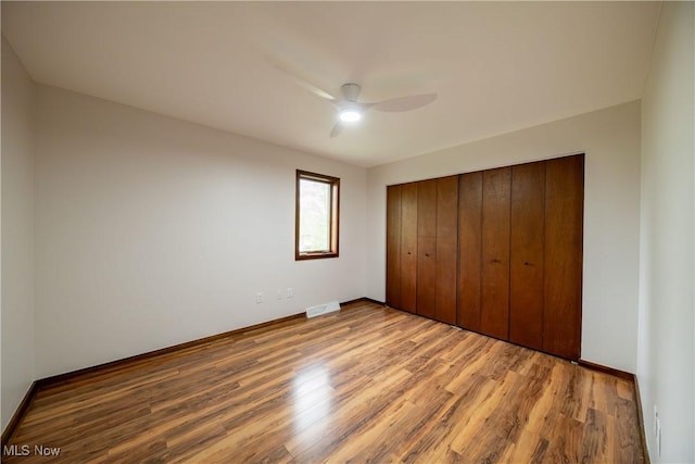 1537 Plantation Dr, Hudson, OH 44236 - unfurnished bedroom featuring wood finished floors, a closet, baseboards, and a ceiling fan
