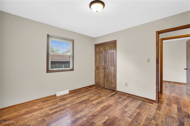 241 W Good Ave, Wadsworth, OH 44281 - unfurnished bedroom with wood finished floors, a closet, and baseboards