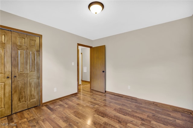 241 W Good Ave, Wadsworth, OH 44281 - unfurnished bedroom with wood finished floors, baseboards, and a closet