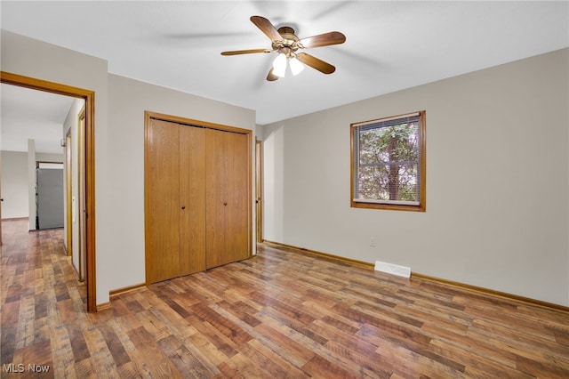 241 W Good Ave, Wadsworth, OH 44281 - unfurnished bedroom with wood finished floors, a closet, baseboards, and a ceiling fan