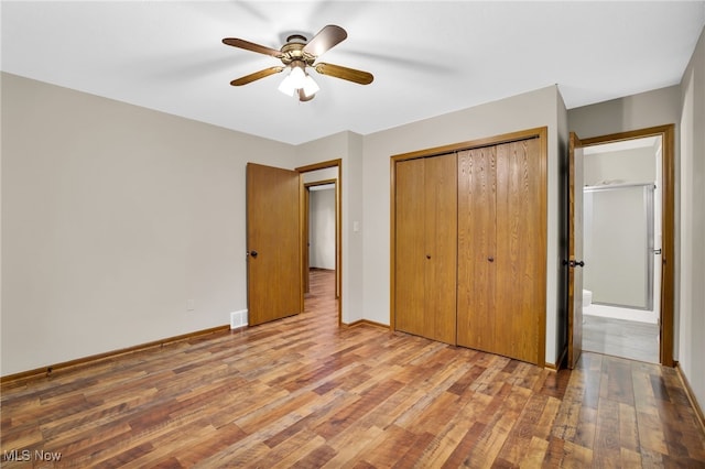 241 W Good Ave, Wadsworth, OH 44281 - unfurnished bedroom featuring wood finished floors, a closet, baseboards, and a ceiling fan