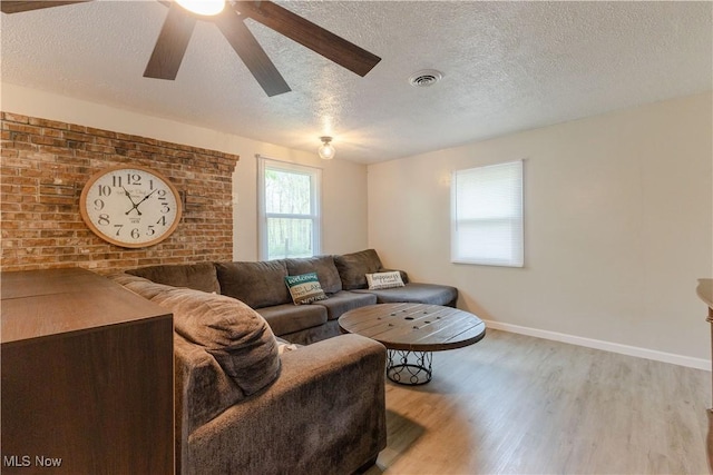 274 2nd St, Lake Milton, OH 44429 - living room with a textured ceiling, light wood-type flooring, baseboards, and ceiling fan