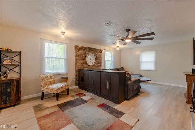 274 2nd St, Lake Milton, OH 44429 - living room featuring a textured ceiling, light wood-type flooring, ceiling fan, and baseboards