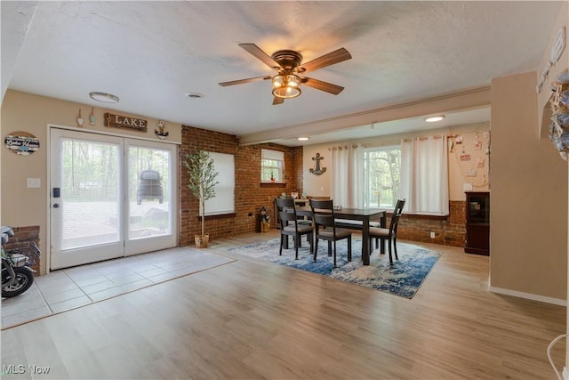 274 2nd St, Lake Milton, OH 44429 - dining area with brick wall, wood finished floors, and ceiling fan