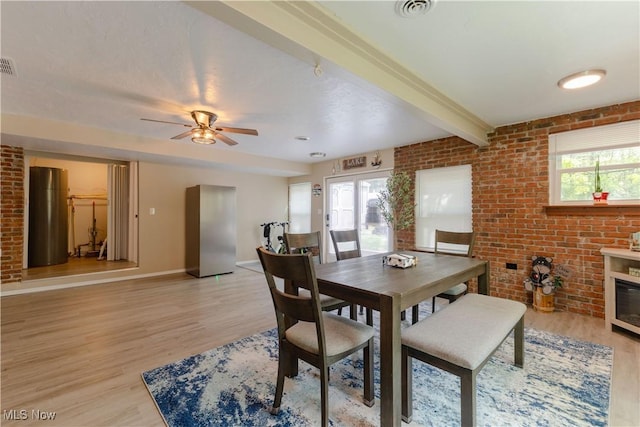 274 2nd St, Lake Milton, OH 44429 - dining room with light wood finished floors, plenty of natural light, brick wall, baseboards, and beam ceiling