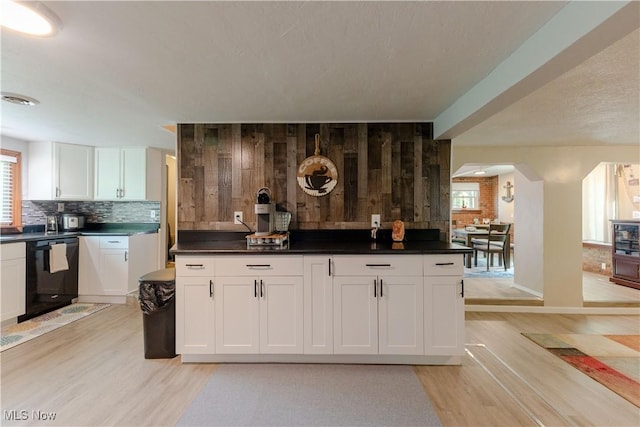 274 2nd St, Lake Milton, OH 44429 - bar with black dishwasher, light wood-style floors, tasteful backsplash, baseboards, and wooden walls