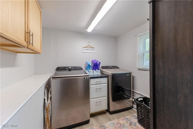 274 2nd St, Lake Milton, OH 44429 - washroom with cabinet space, light wood-style floors, and washing machine and dryer