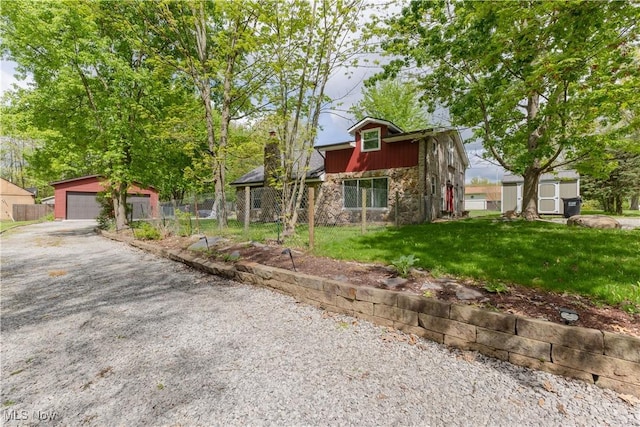 274 2nd St, Lake Milton, OH 44429 - view of front of property with stone siding, an outdoor structure, and a garage