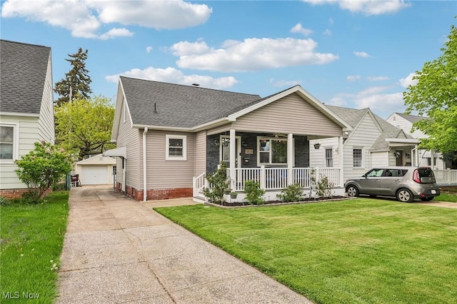 5610 Charles Ave, Parma, OH 44129 - view of front of house featuring covered porch, an outdoor structure, a front yard, and roof with shingles