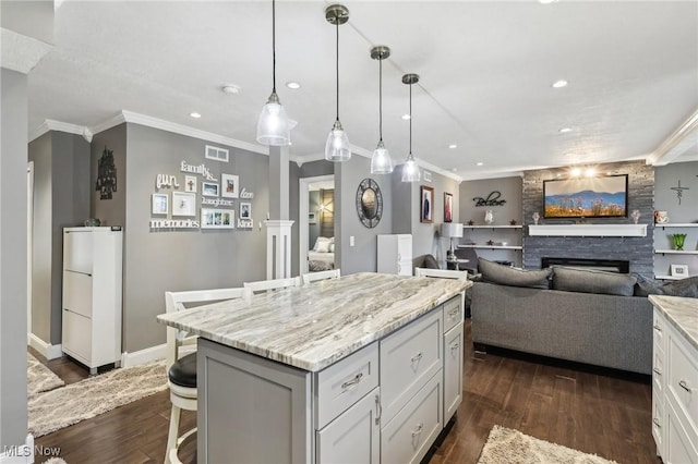 5610 Charles Ave, Parma, OH 44129 - kitchen featuring a breakfast bar area, a fireplace, ornamental molding, dark wood-style flooring, and refrigerator