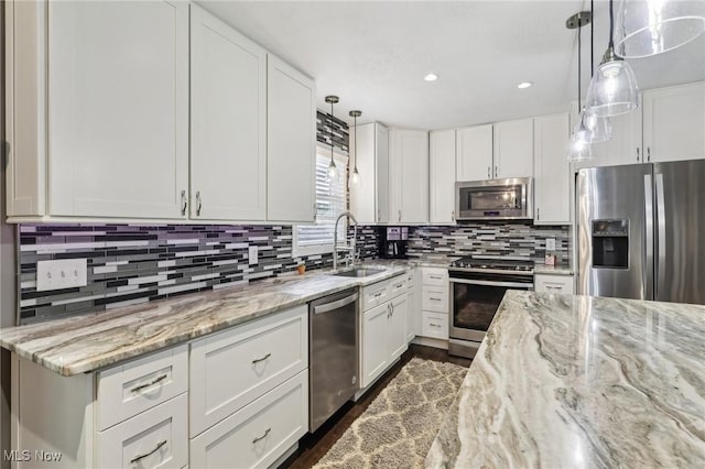 5610 Charles Ave, Parma, OH 44129 - kitchen with appliances with stainless steel finishes, a sink, decorative backsplash, white cabinetry, and recessed lighting