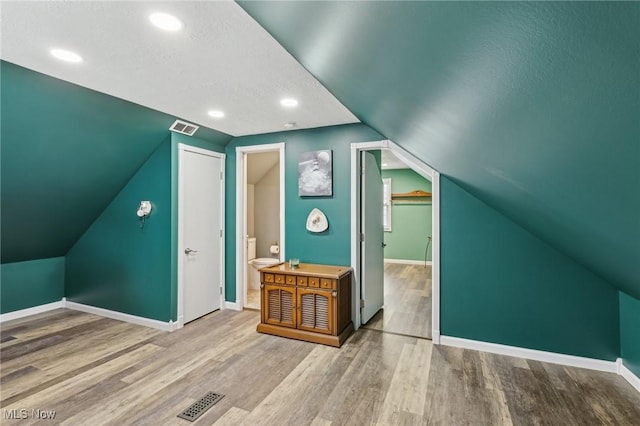 5610 Charles Ave, Parma, OH 44129 - additional living space with wood finished floors, baseboards, lofted ceiling, a textured ceiling, and recessed lighting