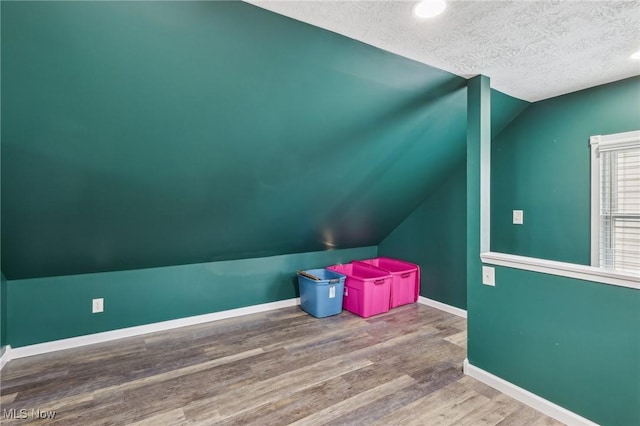 5610 Charles Ave, Parma, OH 44129 - bonus room featuring lofted ceiling, a textured ceiling, wood finished floors, baseboards, and recessed lighting