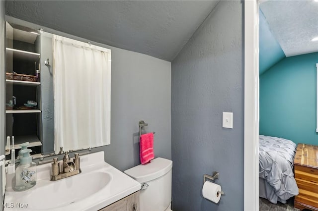 5610 Charles Ave, Parma, OH 44129 - ensuite bathroom with vaulted ceiling, toilet, and vanity