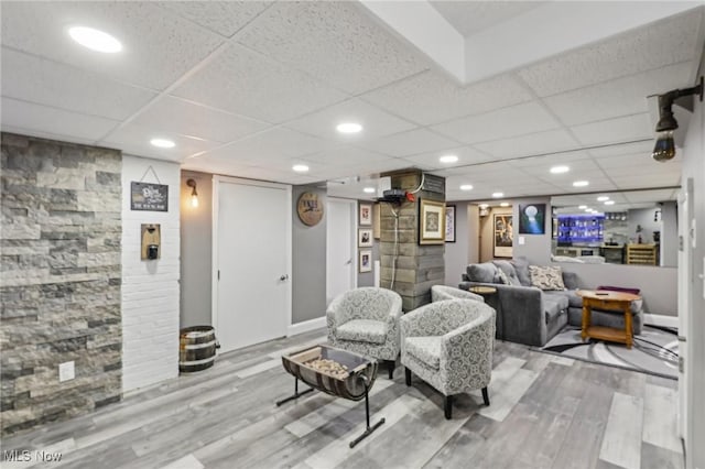 5610 Charles Ave, Parma, OH 44129 - living room with wood finished floors, a paneled ceiling, and baseboards