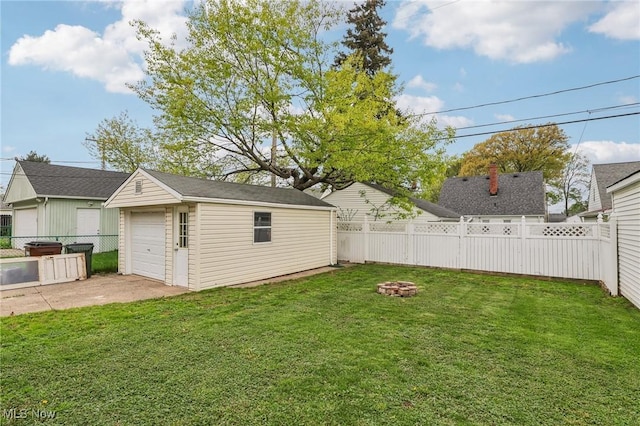 5610 Charles Ave, Parma, OH 44129 - view of yard with an outbuilding, a garage, driveway, and an outdoor fire pit