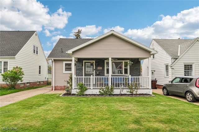 5610 Charles Ave, Parma, OH 44129 - view of front of property with a porch, a front lawn, and roof with shingles