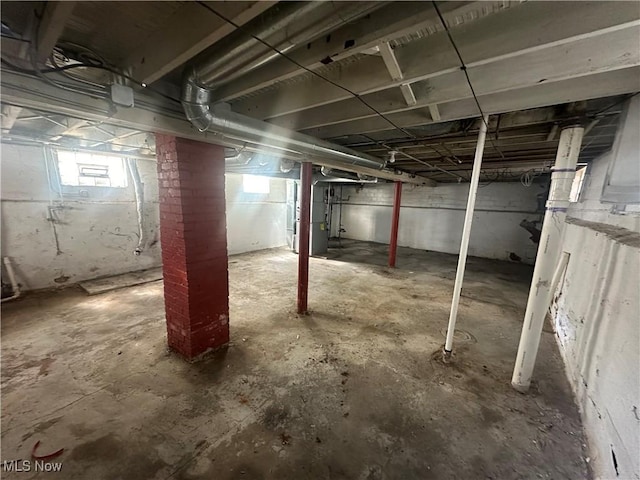 basement featuring healthy amount of natural light and heating unit