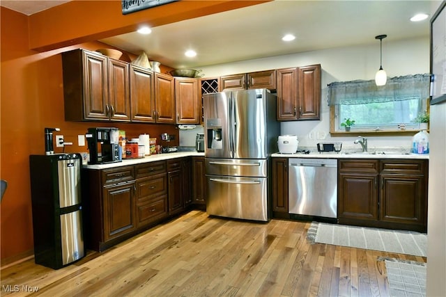 3138 Mccleary Jacoby Rd, Cortland, OH 44410 - kitchen featuring appliances with stainless steel finishes, light countertops, light wood-style floors, decorative light fixtures, and recessed lighting