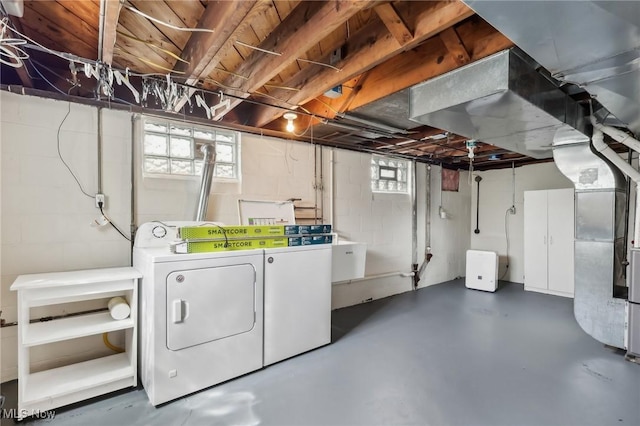 below grade area featuring independent washer and dryer and heating unit