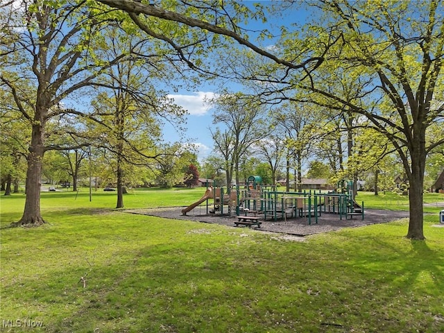 view of community featuring a playground and a lawn