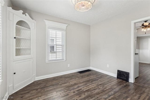 unfurnished bedroom with dark wood-style flooring and baseboards