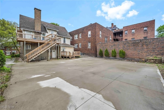 103 N Portage Path, Akron, OH 44303 - rear view of property with a deck, fence, stairway, and a chimney