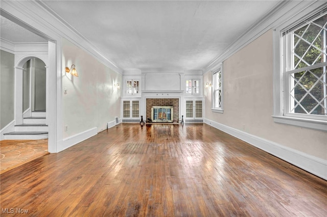 103 N Portage Path, Akron, OH 44303 - unfurnished living room with hardwood / wood-style floors, healthy amount of natural light, a fireplace, baseboards, and crown molding