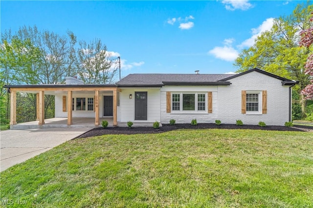 2394 Reimer Rd, Wadsworth, OH 44281 - view of front facade with an attached carport, a front yard, concrete driveway, and brick siding