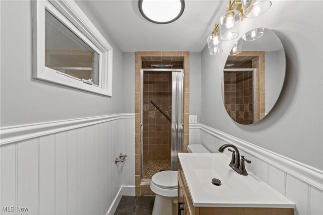 2394 Reimer Rd, Wadsworth, OH 44281 - full bath with a stall shower, wainscoting, toilet, vanity, and a decorative wall