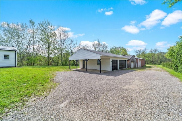 2394 Reimer Rd, Wadsworth, OH 44281 - view of front of house featuring driveway, a front lawn, an outdoor structure, and a garage