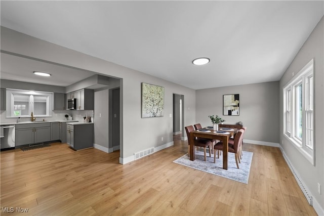 2394 Reimer Rd, Wadsworth, OH 44281 - dining area with light wood-type flooring, baseboards, and baseboard heating