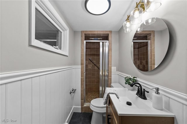 2394 Reimer Rd, Wadsworth, OH 44281 - full bathroom featuring a wainscoted wall, vanity, toilet, a shower stall, and a decorative wall