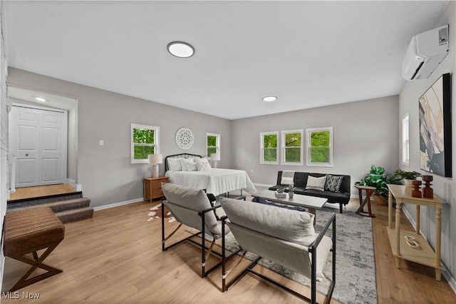 2394 Reimer Rd, Wadsworth, OH 44281 - bedroom featuring a wall mounted air conditioner, light wood-type flooring, baseboards, and recessed lighting