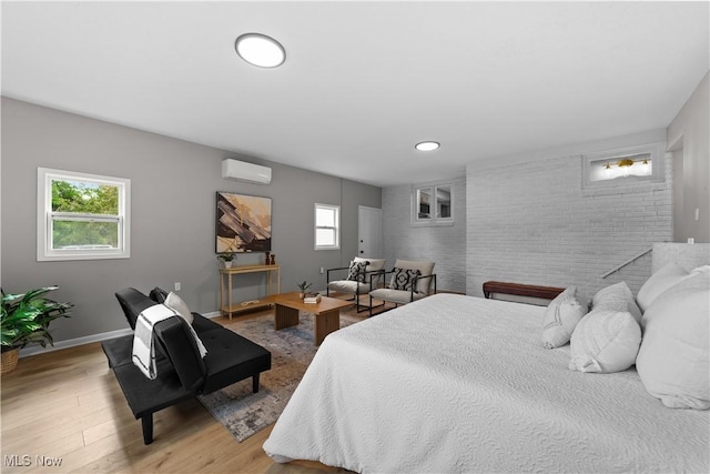 2394 Reimer Rd, Wadsworth, OH 44281 - bedroom featuring a wall mounted air conditioner, brick wall, wood finished floors, an accent wall, and recessed lighting