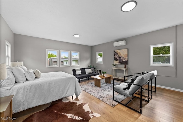 2394 Reimer Rd, Wadsworth, OH 44281 - bedroom featuring an AC wall unit, wood finished floors, and baseboards