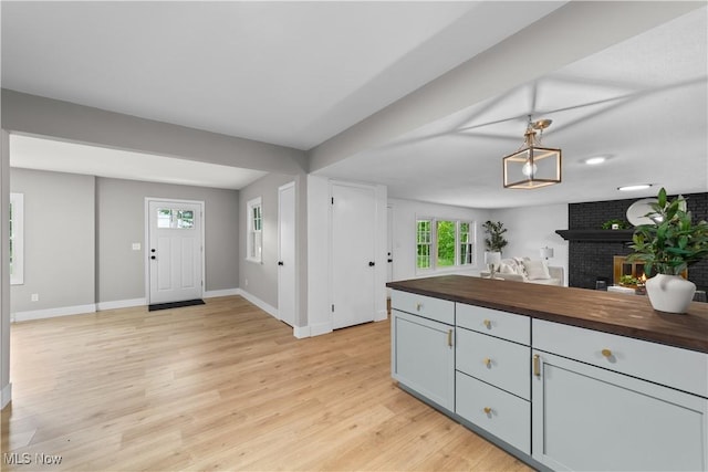 2394 Reimer Rd, Wadsworth, OH 44281 - kitchen with wooden counters, baseboards, open floor plan, light wood finished floors, and plenty of natural light