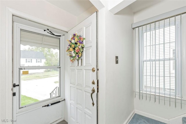 doorway to outside with baseboards